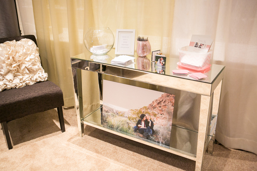 Mirrored table in bridal show booth to hold raffle entry forms and pricing brochures