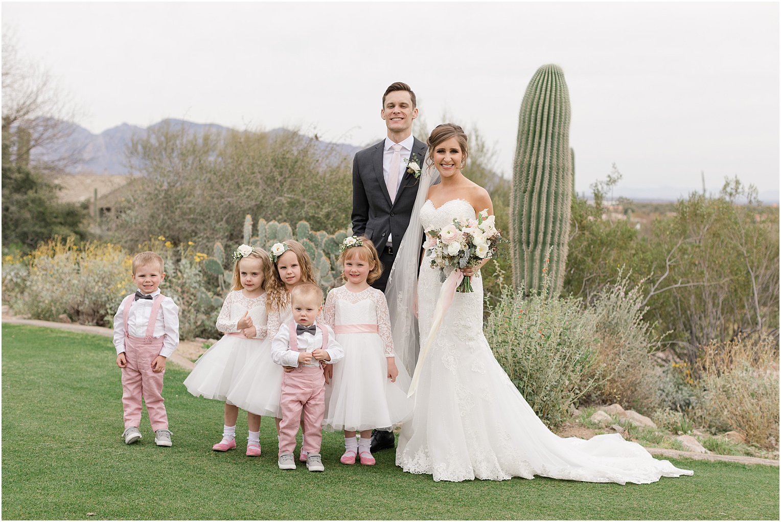 Highlands at Dove Mountain Wedding Grace + Danny bride and groom with flower girls and ring bearers in blush