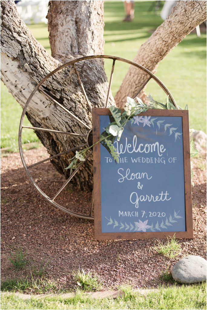 Tanque Verde Ranch Wedding Tucson, AZ Sloan + Garrett outdoor ceremony blue welcome sign with wagon wheel