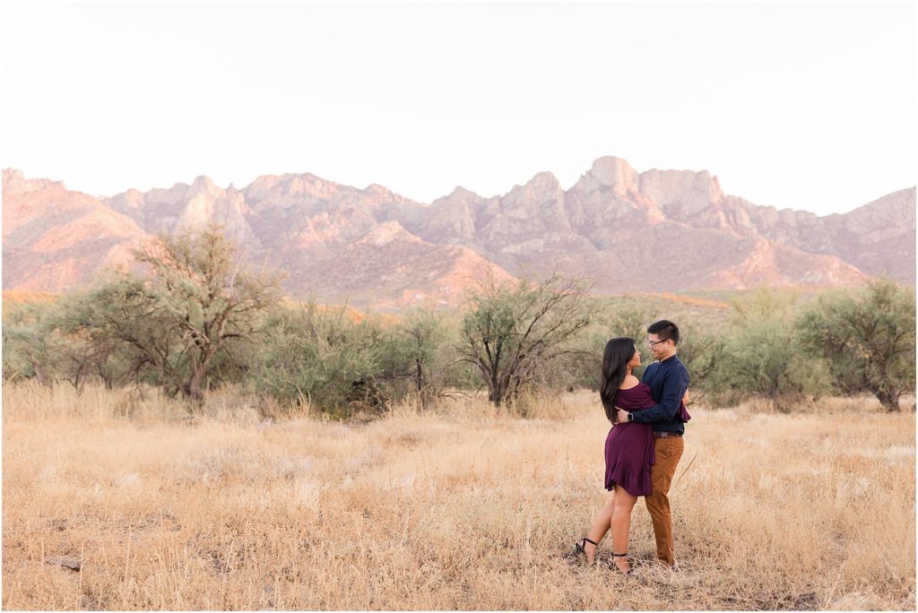 Engagement Photos at Catalina State Park Tucson, AZ Soley + David romantic sunset photos of bride and groom wearing eggplant and navy outfits at their engagement session in the desert