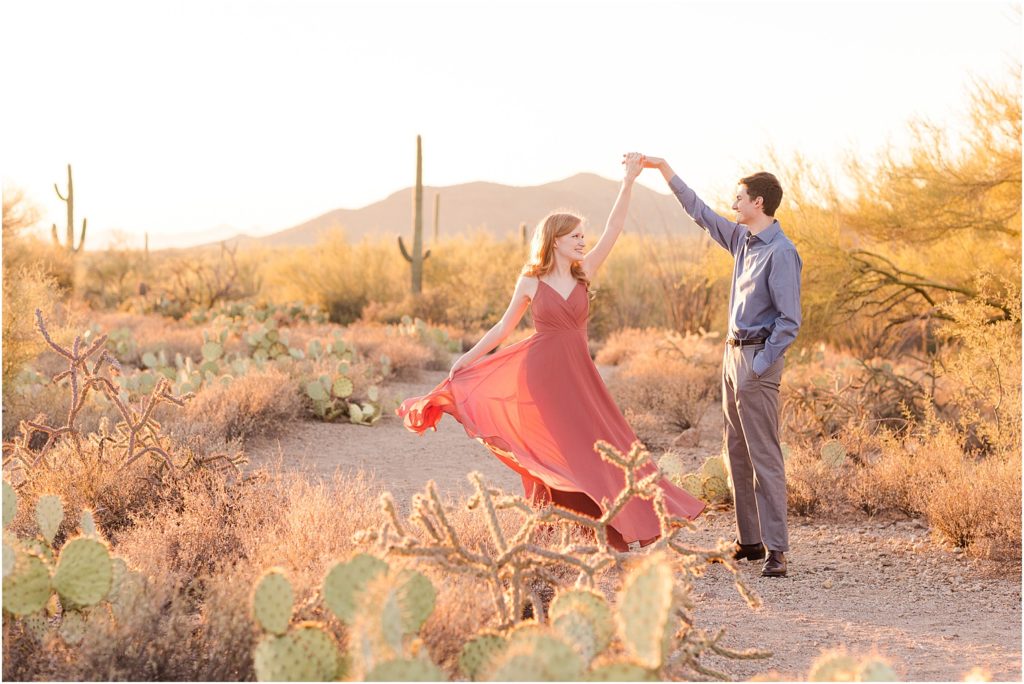 Engagement Photos at Gates Pass Tucson, AZ Abby + Austin romantic sunset photos of bride and groom wearing elegant coral and blue outfits at their engagement session in the desert