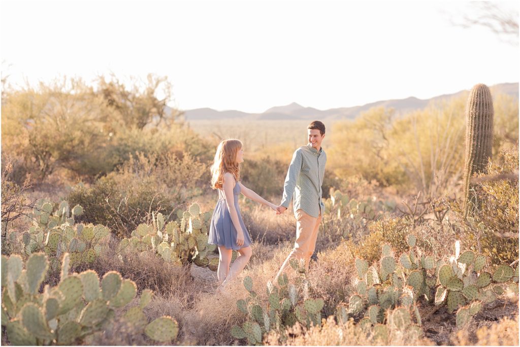 Engagement Photos at Gates Pass Tucson, AZ Abby + Austin romantic engagement photos in the desert at sunset with bride in dusty blue knee length dress