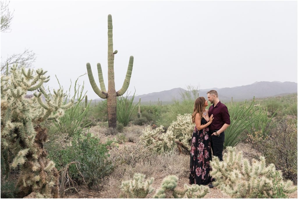 Gates Pass Engagement Session Tucson, AZ Nitasha + Kyle romantic and fun desert engagement session photo with bride in floor length black and pink floral dress