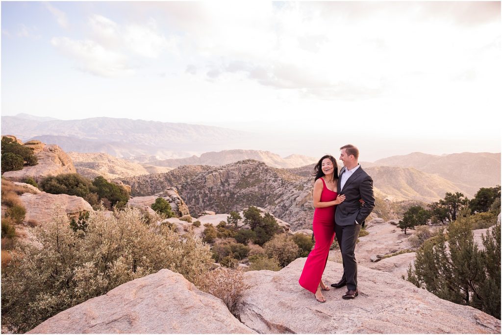 Sunset Photo Session on Mount Lemmon Tucson, AZ Katrina + Nick romantic engagement photo session with bride in a classic red dress and dramatic mountain views in background 