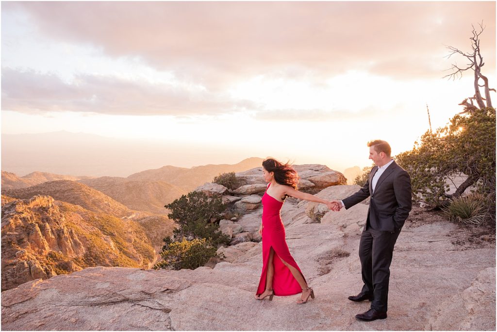 Sunset Photo Session on Mount Lemmon Tucson, AZ Katrina + Nick romantic engagement photo session with bride in a stunning red dress and dramatic mountain views in background 