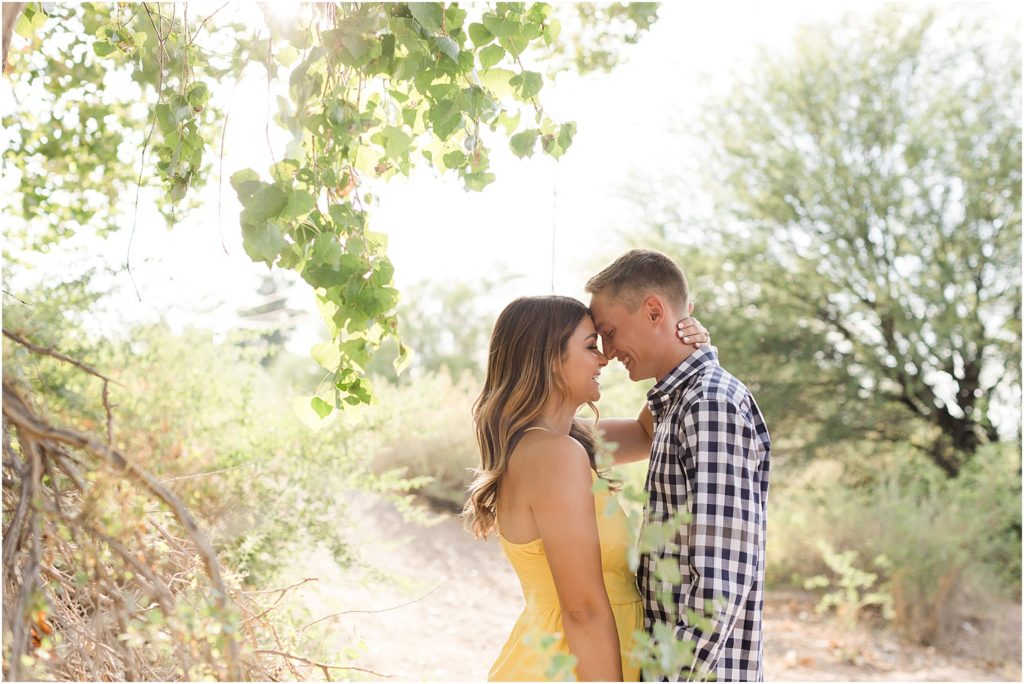Tucson Desert Engagement Photos Tucson, Arizona Ellie + Danny romantic engagement photos in the desert with bride in yellow sundress and groom in casual gingham plaid button up shirt