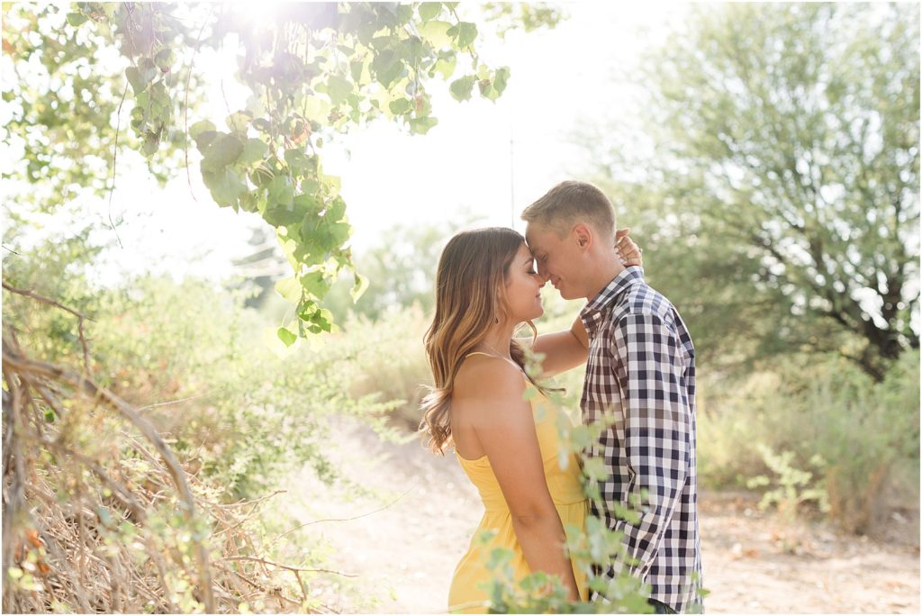 Tucson Desert Engagement Photos Tucson, Arizona Ellie + Danny romantic engagement photos in the desert with bride in yellow sundress and groom in casual gingham plaid button up shirt