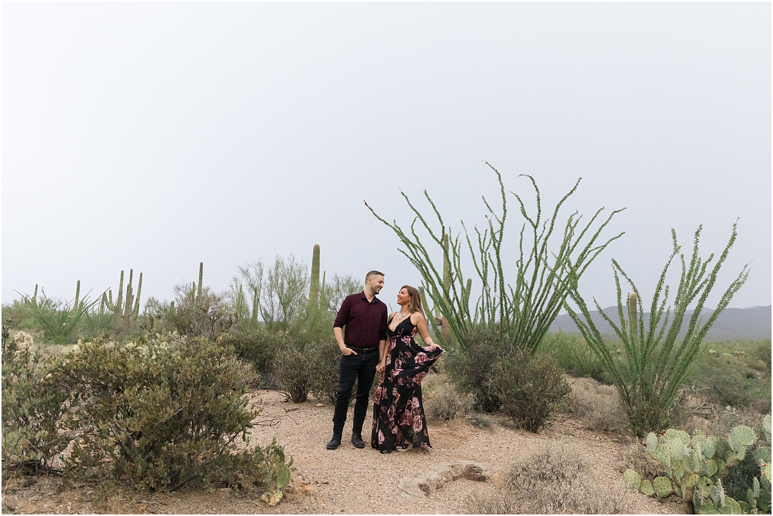 Gates Pass Engagement Session Tucson, AZ Nitasha + Kyle romantic and fun desert engagement session photo with bride in floor length black and pink floral dress